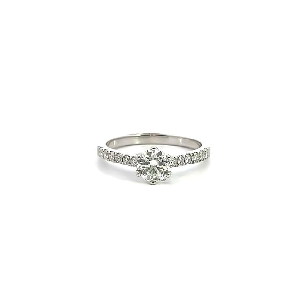 18ct white gold diamond ring with a six-claw 0.70ct round brilliant cut centre diamond and raised claw-set diamond shoulders.