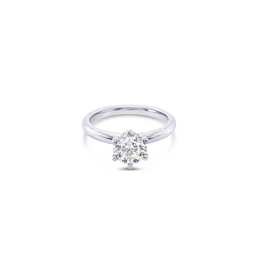 Platinum solitaire diamond ring featuring a 1.06ct round brilliant cut diamond in a six-claw setting.