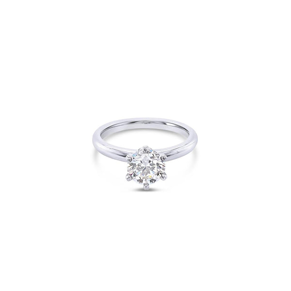 Platinum solitaire diamond ring featuring a 1.06ct round brilliant cut diamond in a six-claw setting.