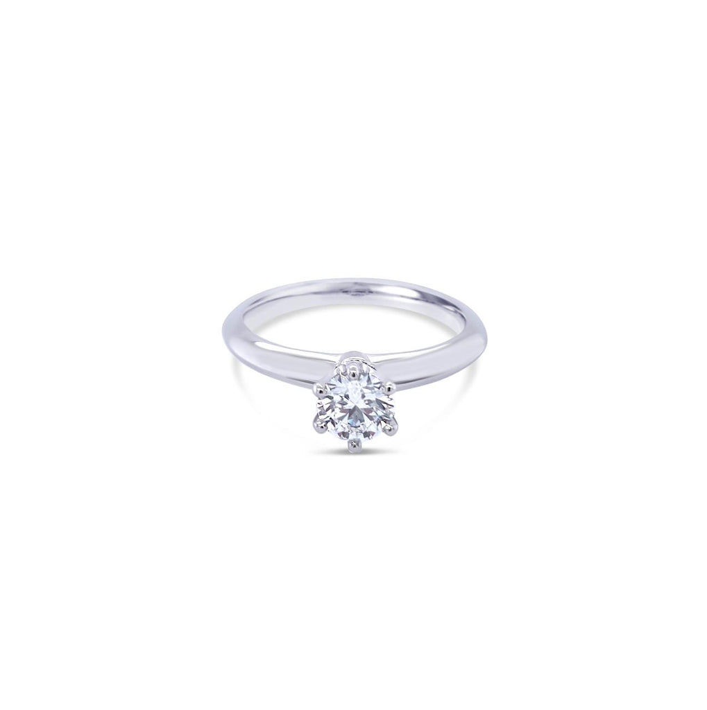 Platinum round brilliant cut 0.50ct solitaire diamond ring with six-claw setting and knife-edge shoulders.