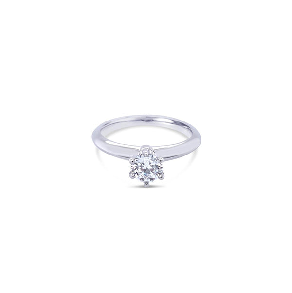 Platinum round brilliant cut 0.50ct solitaire diamond ring with six-claw setting and knife-edge shoulders.