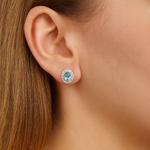 Elegant 18ct white gold aquamarine and diamond halo earrings by James Thredgold Jeweller.