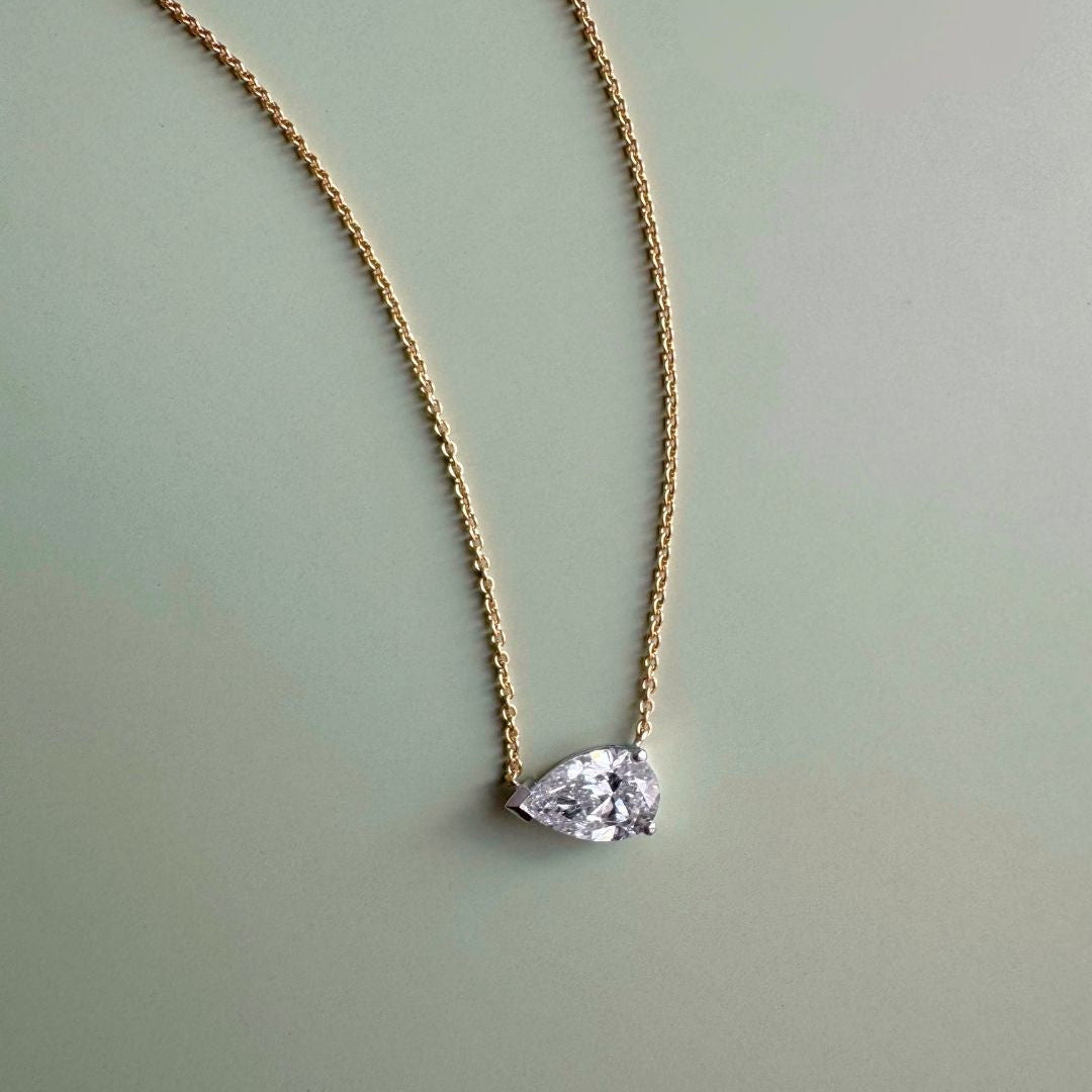 18ct yellow and white gold east-west necklet with GIA certified 1.01ct natural pear brilliant cut diamond