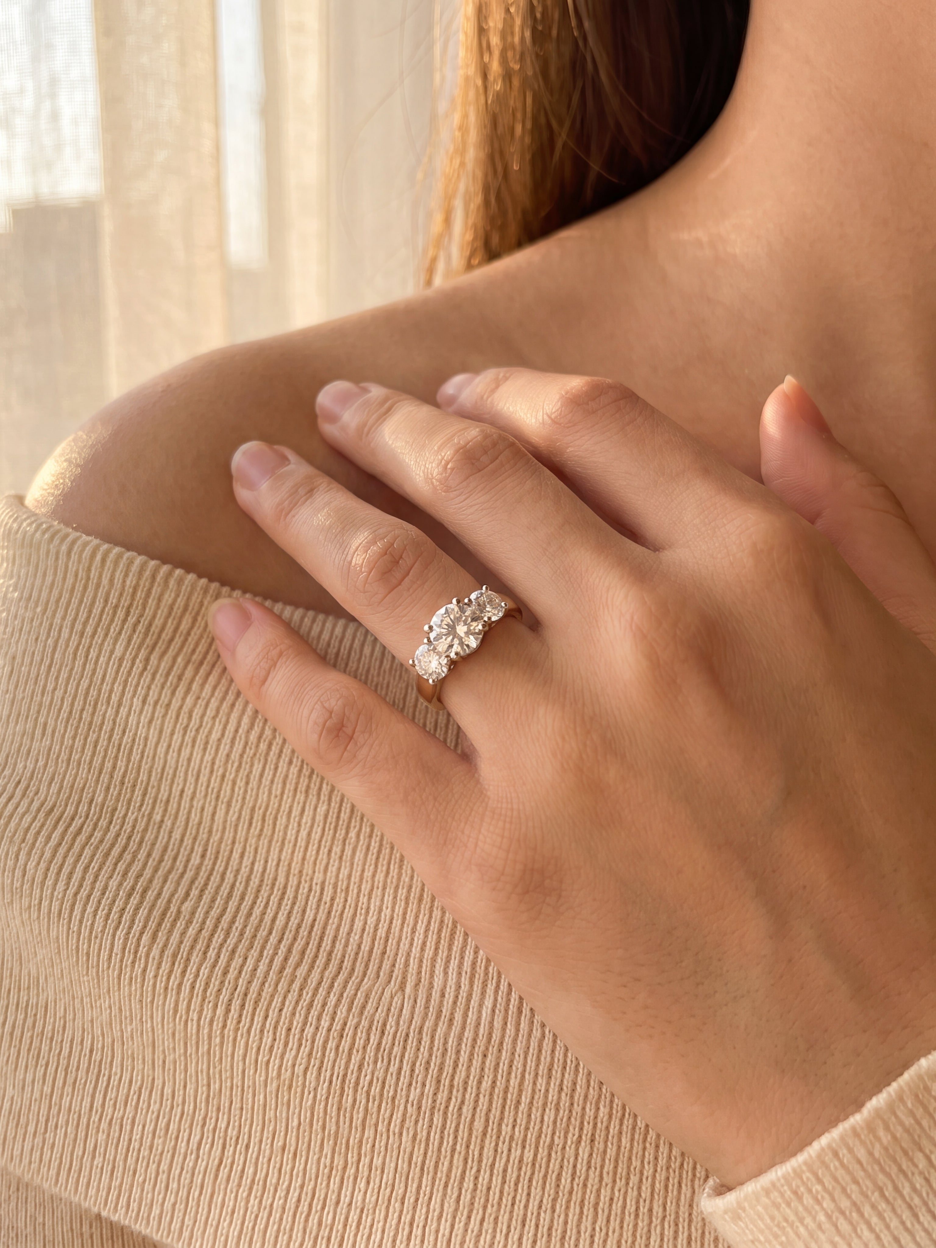 18ct yellow and white gold three stone diamond ring with 1.37ct centre diamond and two round brilliant side diamonds.