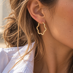 9ct yellow gold twist wave hoop earrings with sculptural curved design, polished finish and hinged clip catch, 23mm diameter