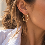 9ct yellow gold twist wave hoop earrings with sculptural curved design, polished finish and hinged clip catch, 23mm diameter