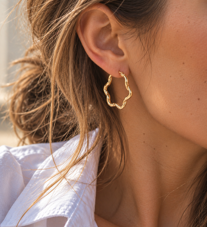 9ct yellow gold twist wave hoop earrings with sculptural curved design, polished finish and hinged clip catch, 23mm diameter