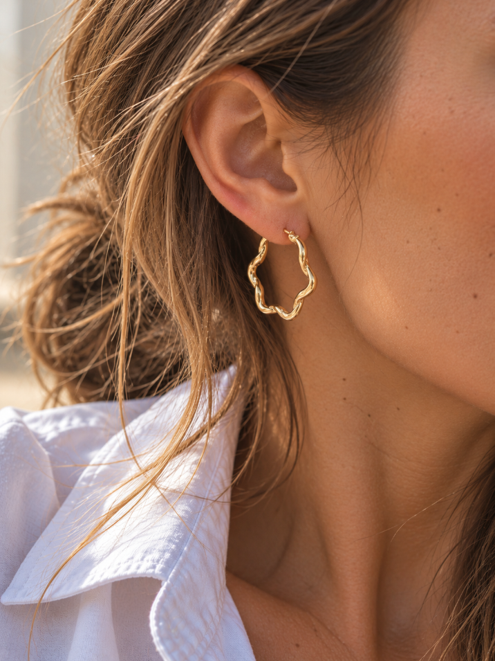 9ct yellow gold twist wave hoop earrings with sculptural curved design, polished finish and hinged clip catch, 23mm diameter