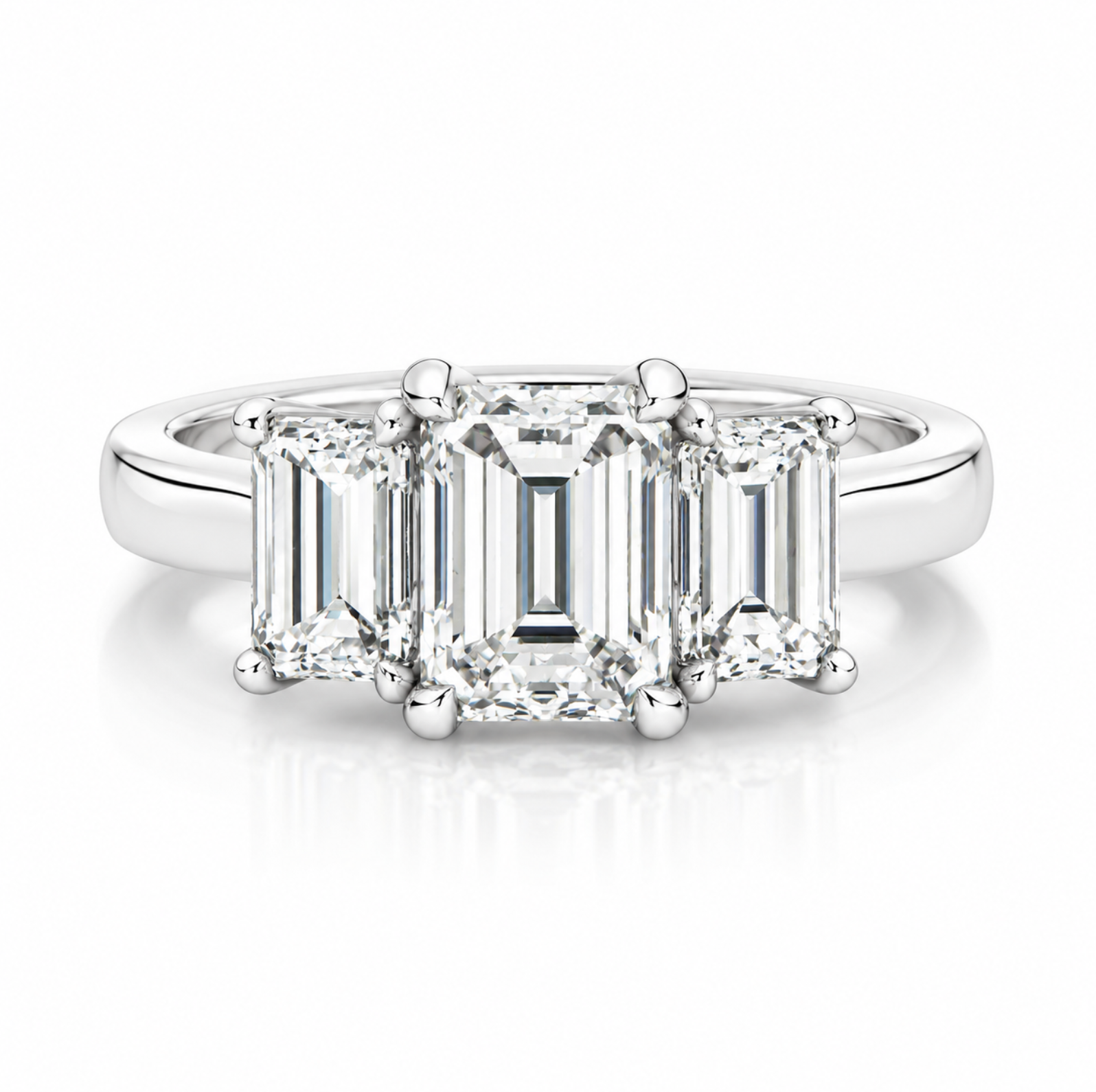 A three-stone diamond engagement ring featuring an emerald-cut center stone and baguette-cut side stones in a platinum metal setting, shown on a clean white background with a soft reflection.