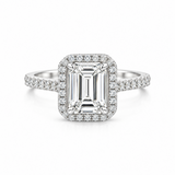 An emerald-cut halo ring featuring a large rectangular center stone surrounded by a halo of small round diamonds, set on a slim pavé band, shown against a plain white background.