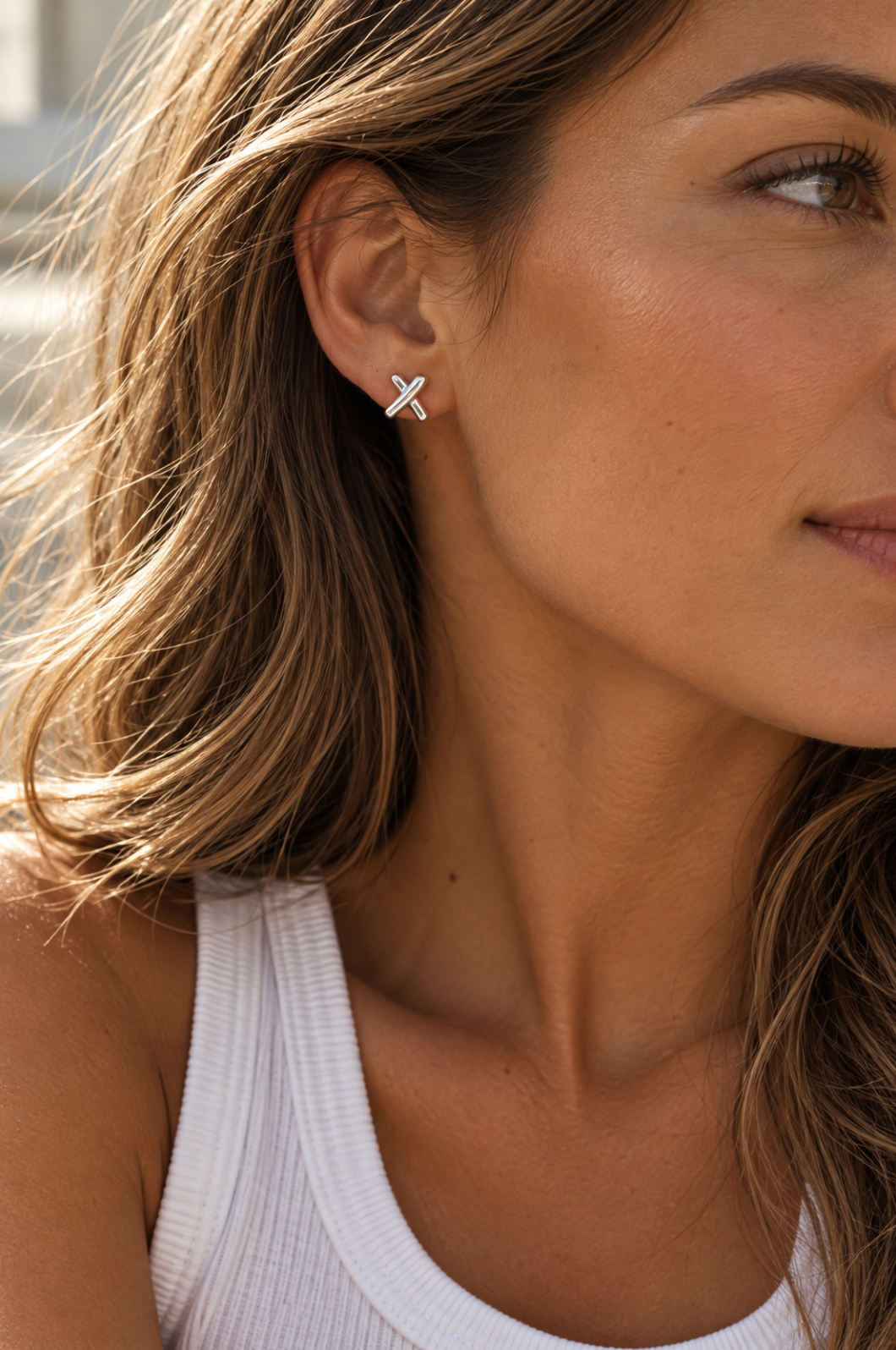Sterling silver Cross Kiss stud earrings with polished intersecting design.