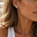 Sterling silver Cross Kiss stud earrings with polished intersecting design.