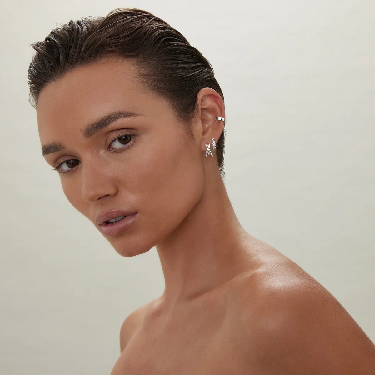 Sterling silver double-strand huggie earrings with polished crossover X design.