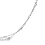 Platinum double strand diamond station necklet with twelve bezel set natural round brilliant cut diamonds on fine trace chains, 40cm long.