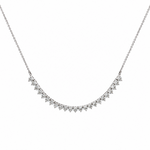 A delicate white gold necklace featuring a curved line of diamonds in a prong setting, suspended from a fine chain against a plain white background.