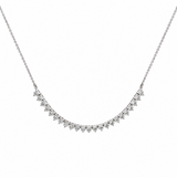 A delicate white gold necklace featuring a curved line of diamonds in a prong setting, suspended from a fine chain against a plain white background.