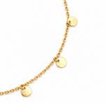 Close-up of polished gold disc drops suspended from a 9ct yellow gold trace link bracelet.