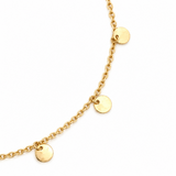 Close-up of polished gold disc drops suspended from a 9ct yellow gold trace link bracelet.