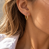 9ct yellow gold pentagon huggie earrings with a flat, angular profile and polished finish, measuring 17mm in diameter.