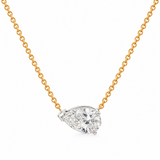 A pear-cut diamond pendant necklace on a gold chain, set against a clean white background.