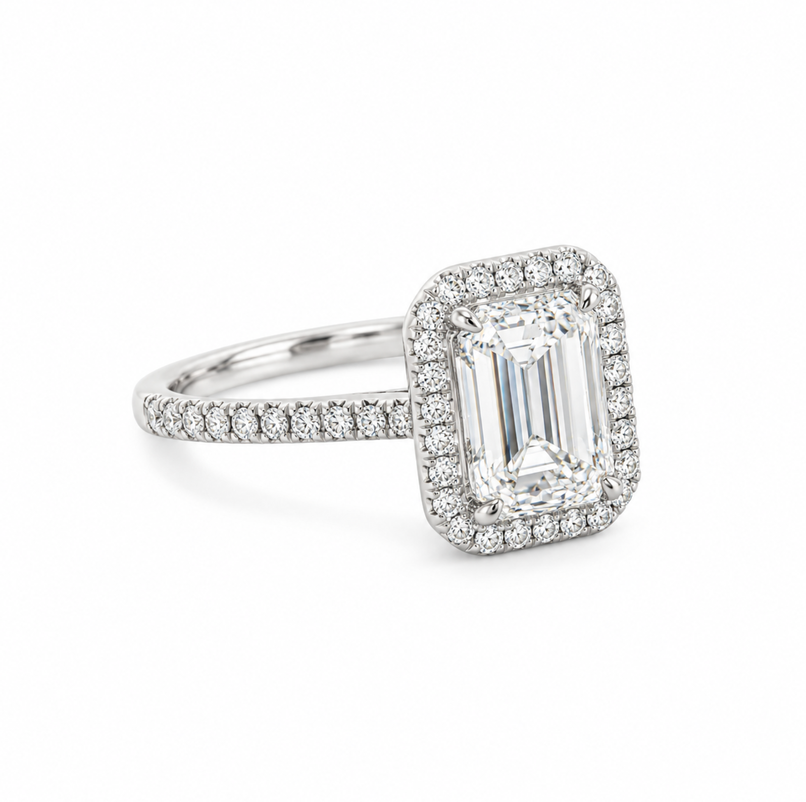 An emerald-cut halo ring featuring a large clear center stone surrounded by a halo and a pavé-set band, shown on a clean white background.