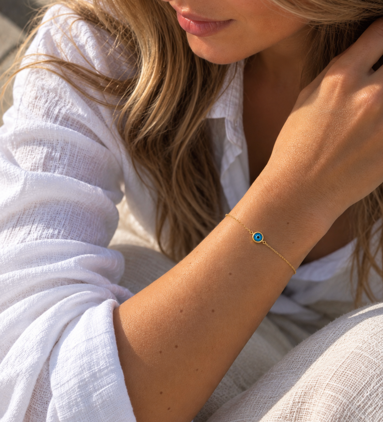 9ct yellow gold fine trace link bracelet with a blue Evil Eye centre charm and bolt ring clasp.
