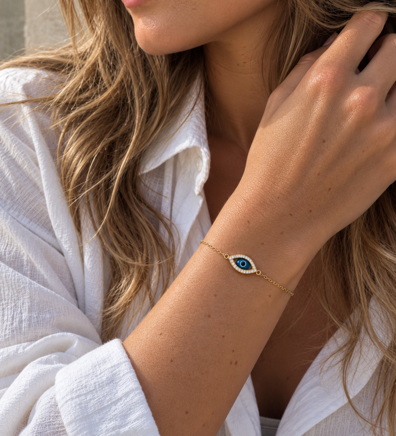9ct yellow gold fine trace link bracelet featuring a marquise-shaped Evil Eye charm with a cubic zirconia surround and parrot clasp.