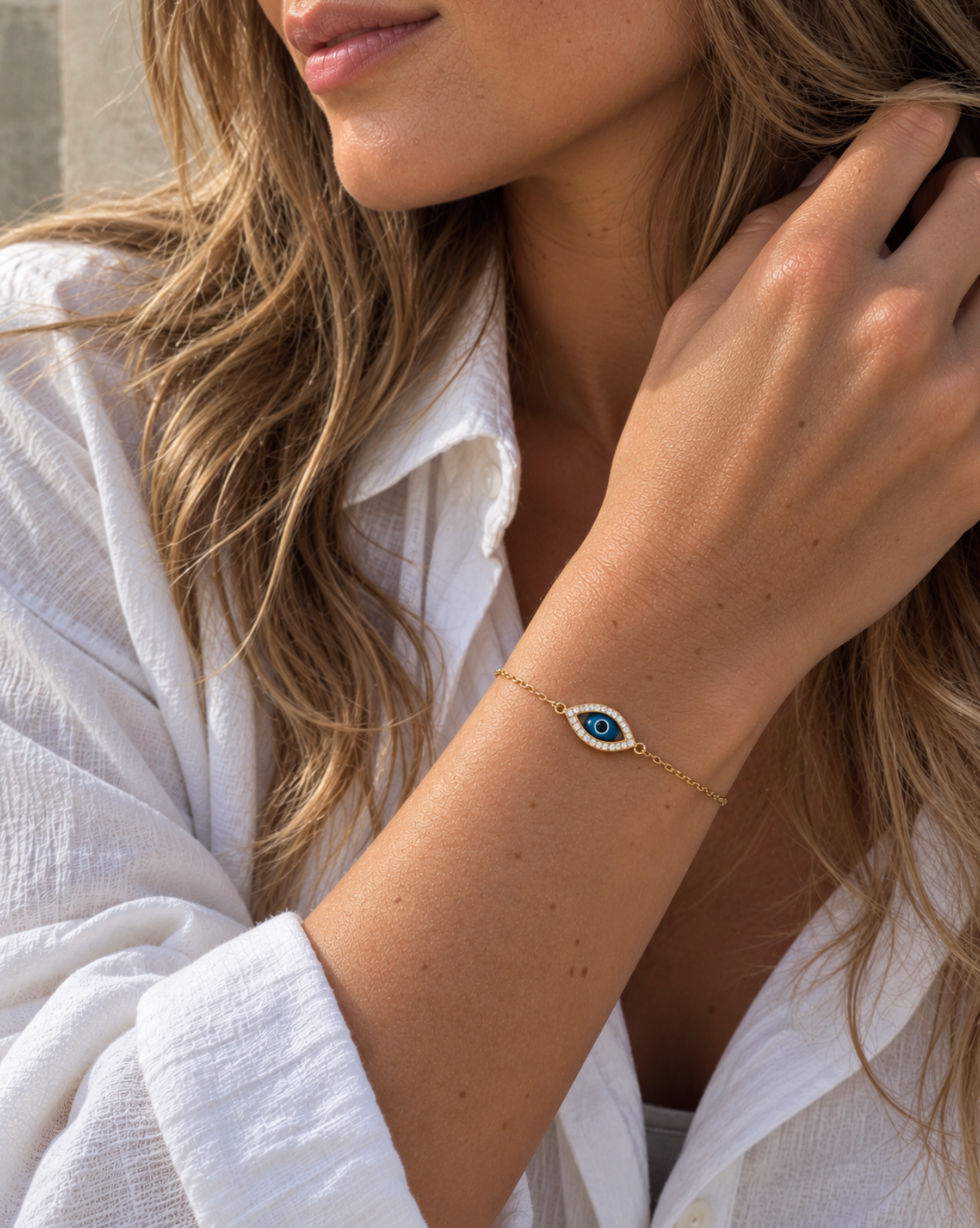 9ct yellow gold fine trace link bracelet featuring a marquise-shaped Evil Eye charm with a cubic zirconia surround and parrot clasp.