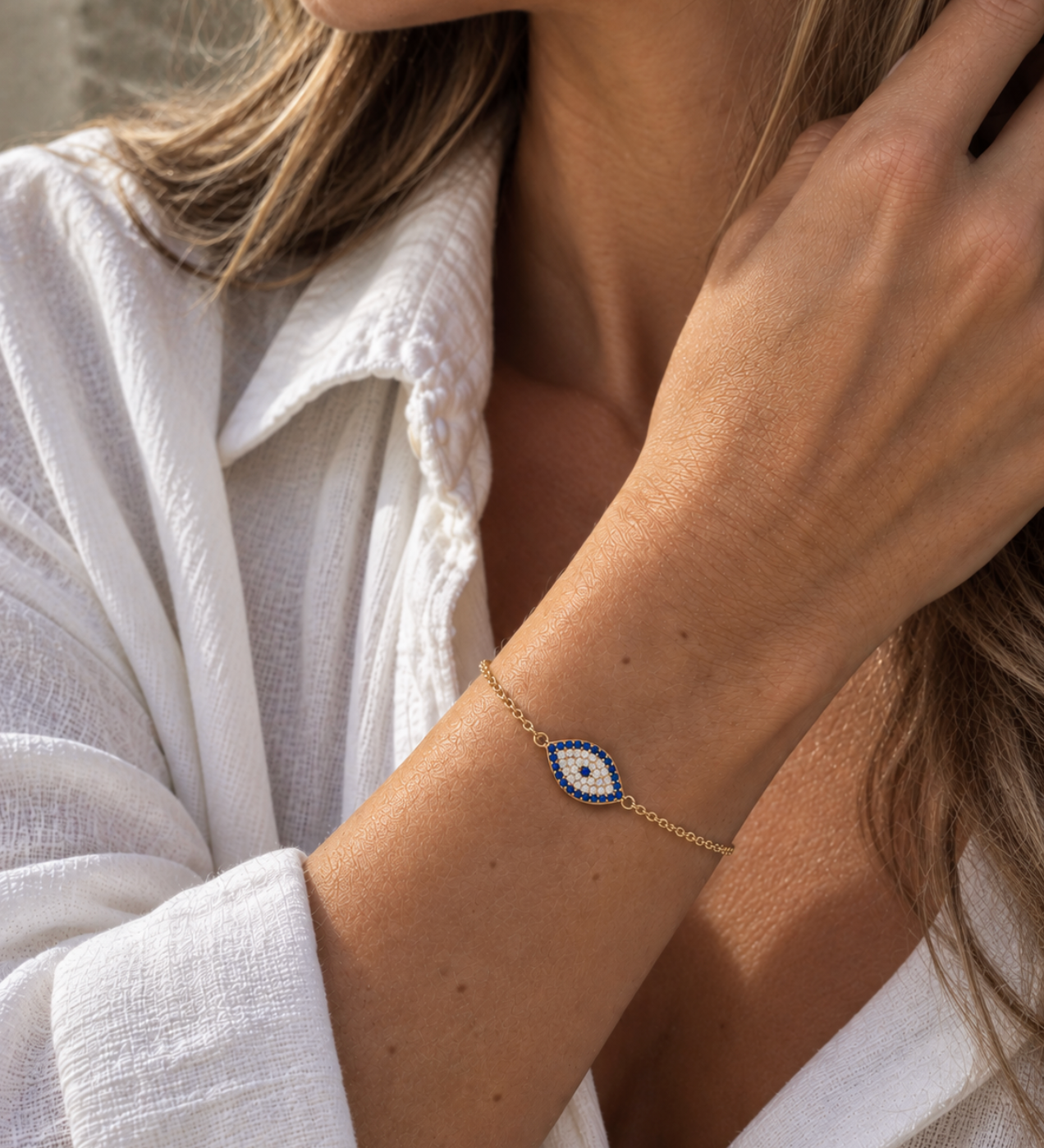 9ct yellow gold Evil Eye cubic zirconia bracelet worn on the wrist.