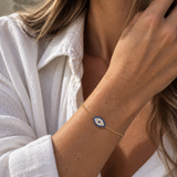 9ct yellow gold Evil Eye cubic zirconia bracelet worn on the wrist.