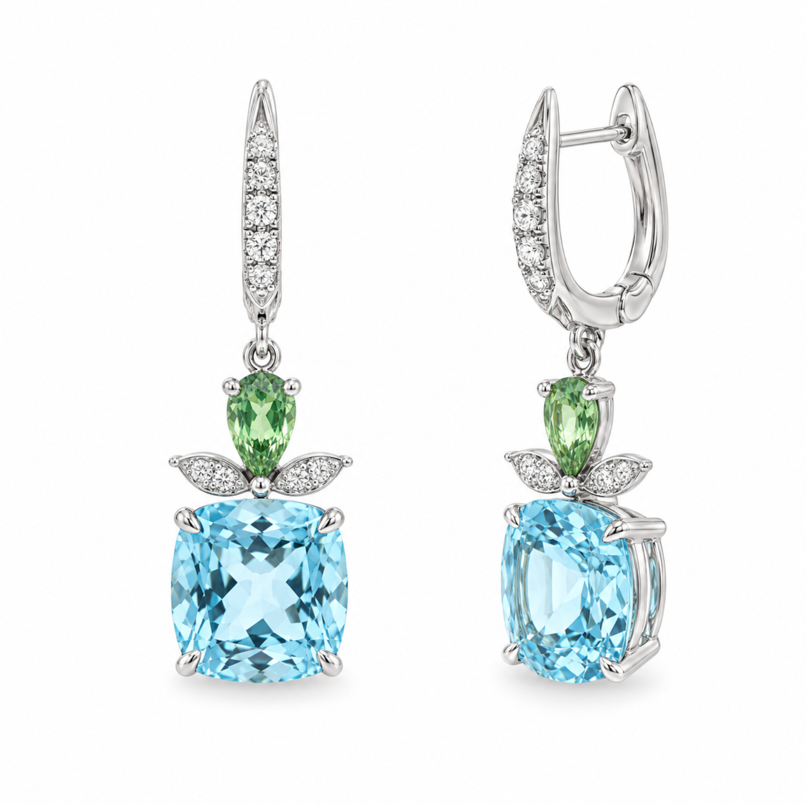 A pair of white gold drop earrings featuring cushion-cut light blue topaz stones, pear-cut green tsavorite stones, small clear pavé diamonds, and leaf-shaped white gold settings, shown on a plain white background.