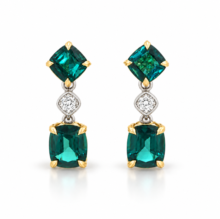 A pair of gold drop earrings featuring square-cut emerald-cut green gemstones and a small round diamond in the center, set against a clean white background.