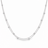 Platinum double strand diamond station necklet with twelve bezel set natural round brilliant cut diamonds on fine trace chains, 40cm long.