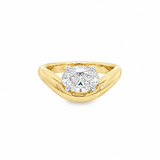 A yellow gold ring featuring a oval brilliant-cut diamond east west setting, cured yellow old band