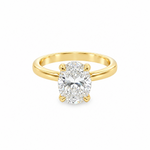 A yellow gold solitaire ring featuring a large oval-cut diamond in a four-prong setting, shown on a clean white background.