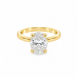 A yellow gold solitaire ring featuring a large oval-cut diamond in a four-prong setting, shown on a clean white background.