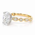Side view of 2.50ct oval diamond engagement ring showing the white gold centre setting and yellow gold diamond-set shoulders.