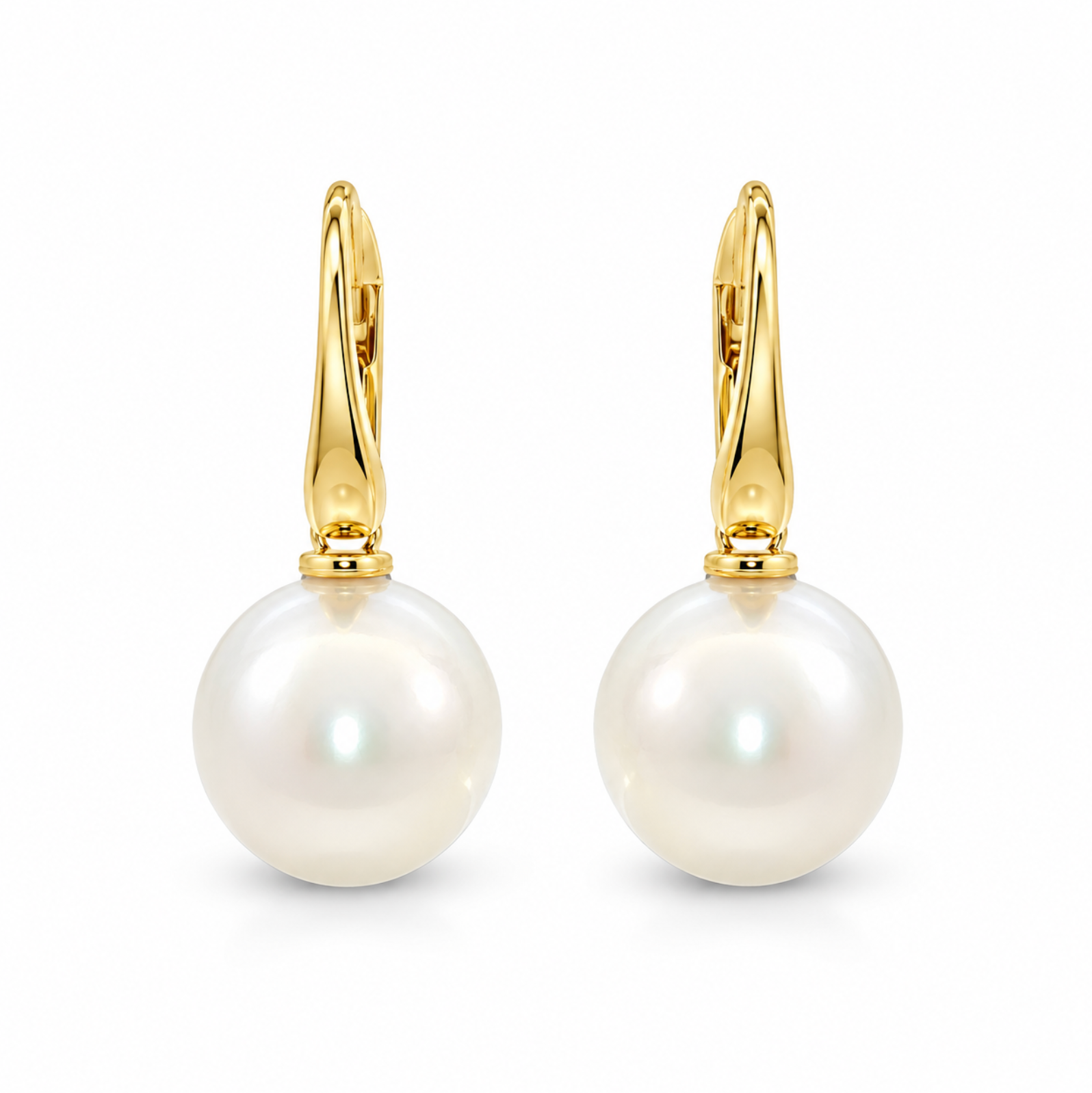 A pair of gold huggie hoop earrings with large, lustrous white South Sea pearls hanging from gold posts, shown on a clean white background.