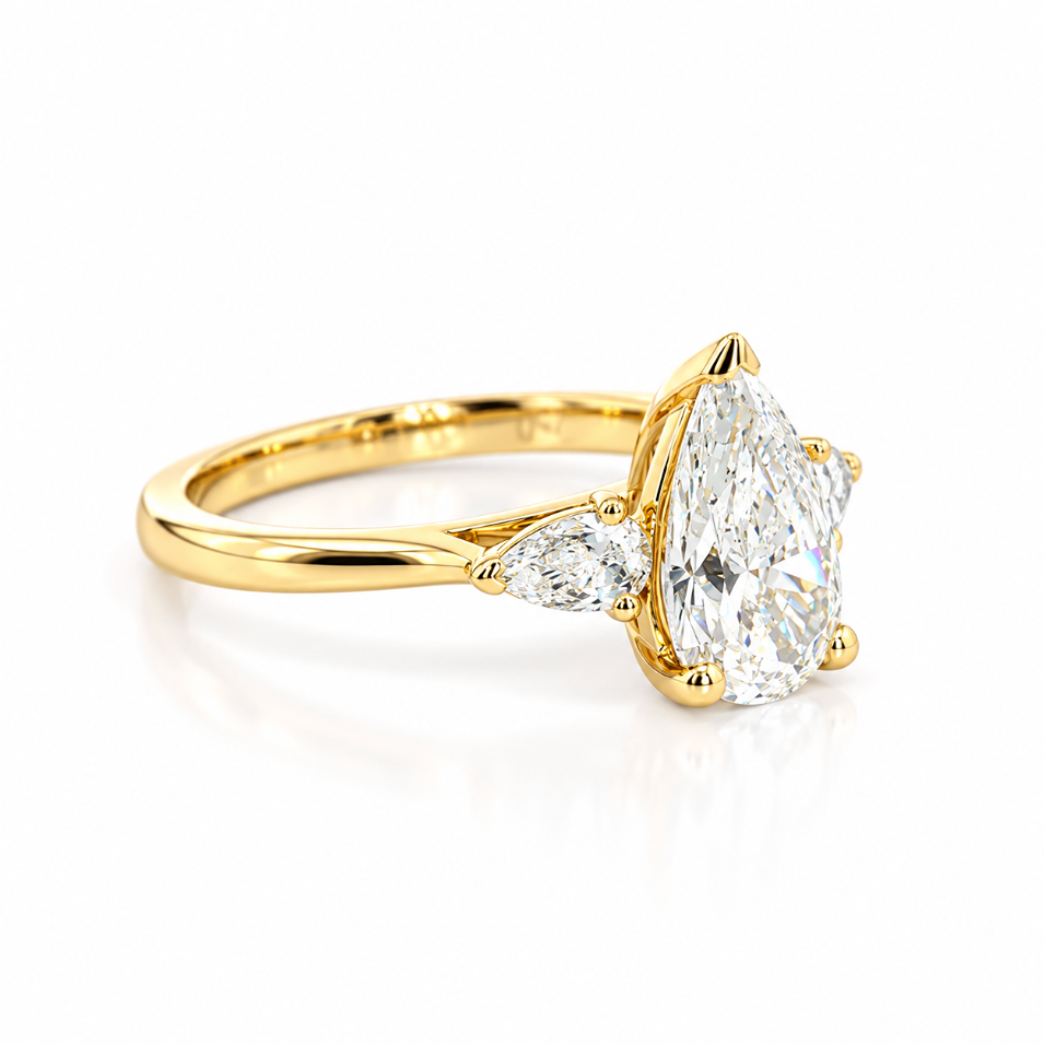 Three-stone pear diamond engagement ring in 18ct yellow gold with vertically set centre diamond and horizontal pear-shaped side stones.