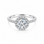 18ct white gold diamond halo ring featuring a 1.01ct round brilliant cut centre diamond with a circular diamond halo and claw-set shoulders.