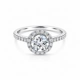 18ct white gold diamond halo ring featuring a 1.01ct round brilliant cut centre diamond with a circular diamond halo and claw-set shoulders.