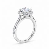 18ct white gold diamond halo ring featuring a 1.01ct round brilliant cut centre diamond with a circular diamond halo and claw-set shoulders.