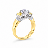 18ct yellow and white gold diamond ring featuring a 0.91ct cushion cut centre diamond with Fancy Yellow side diamonds and round diamond accents.