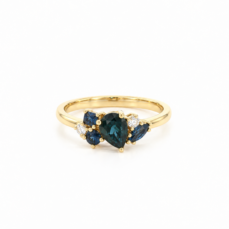 18ct yellow gold ring featuring a random cluster of Australian blue sapphires in pear, round, and marquise cuts with diamond accents and a post and bezel undercarriage.
