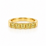 A yellow gold eternity ring featuring five asscher-cut yellow gemstones in a prong setting, displayed on a clean white background with a soft reflection.