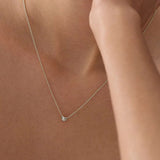 Sterling silver puff heart necklet worn on the neckline.