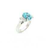 18ct white gold aquamarine and diamond cluster ring featuring a 3.22ct oval aquamarine with oval and pear-cut diamond spray clusters.