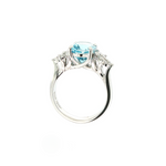 18ct white gold aquamarine and diamond cluster ring featuring a 3.22ct oval aquamarine with oval and pear-cut diamond spray clusters.