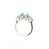 18ct white gold aquamarine and diamond cluster ring featuring a 3.22ct oval aquamarine with oval and pear-cut diamond spray clusters.