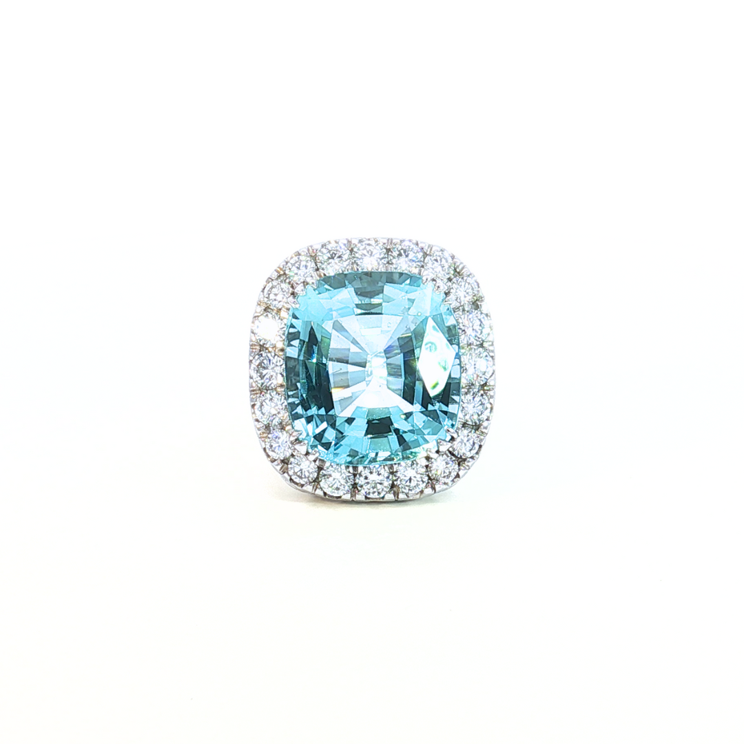 18ct white gold aquamarine and diamond ring featuring a 15.77ct cushion cut aquamarine surrounded by a cushion-shaped diamond halo.